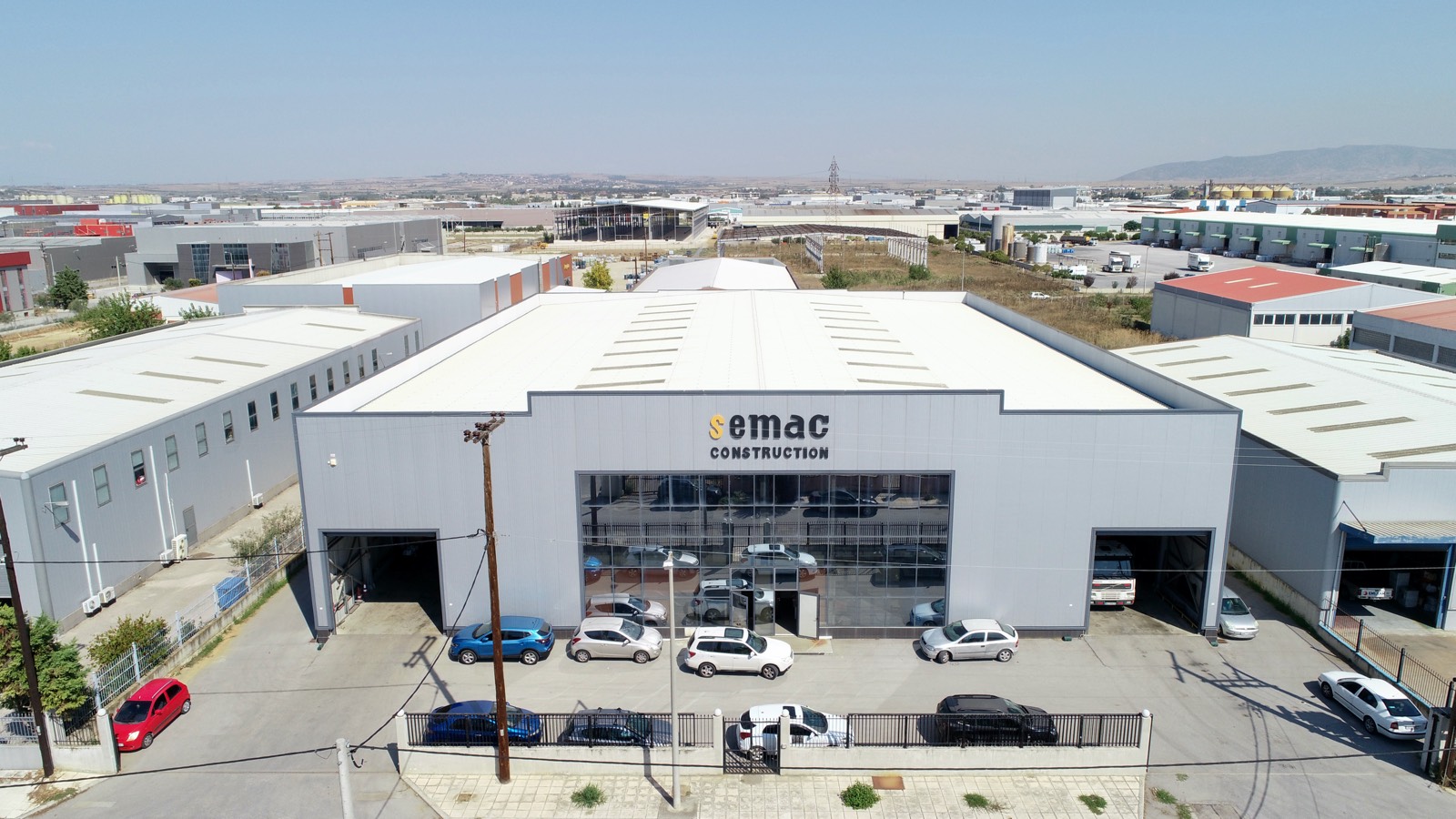 Aerial view of the SEMAC Construction industrial building, with the semac CONSTRUCTION sign